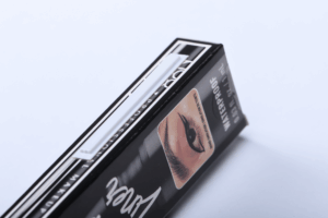 photographie d'une étiquette antivol cosmétique AM posée sur une boite d'eye liner.